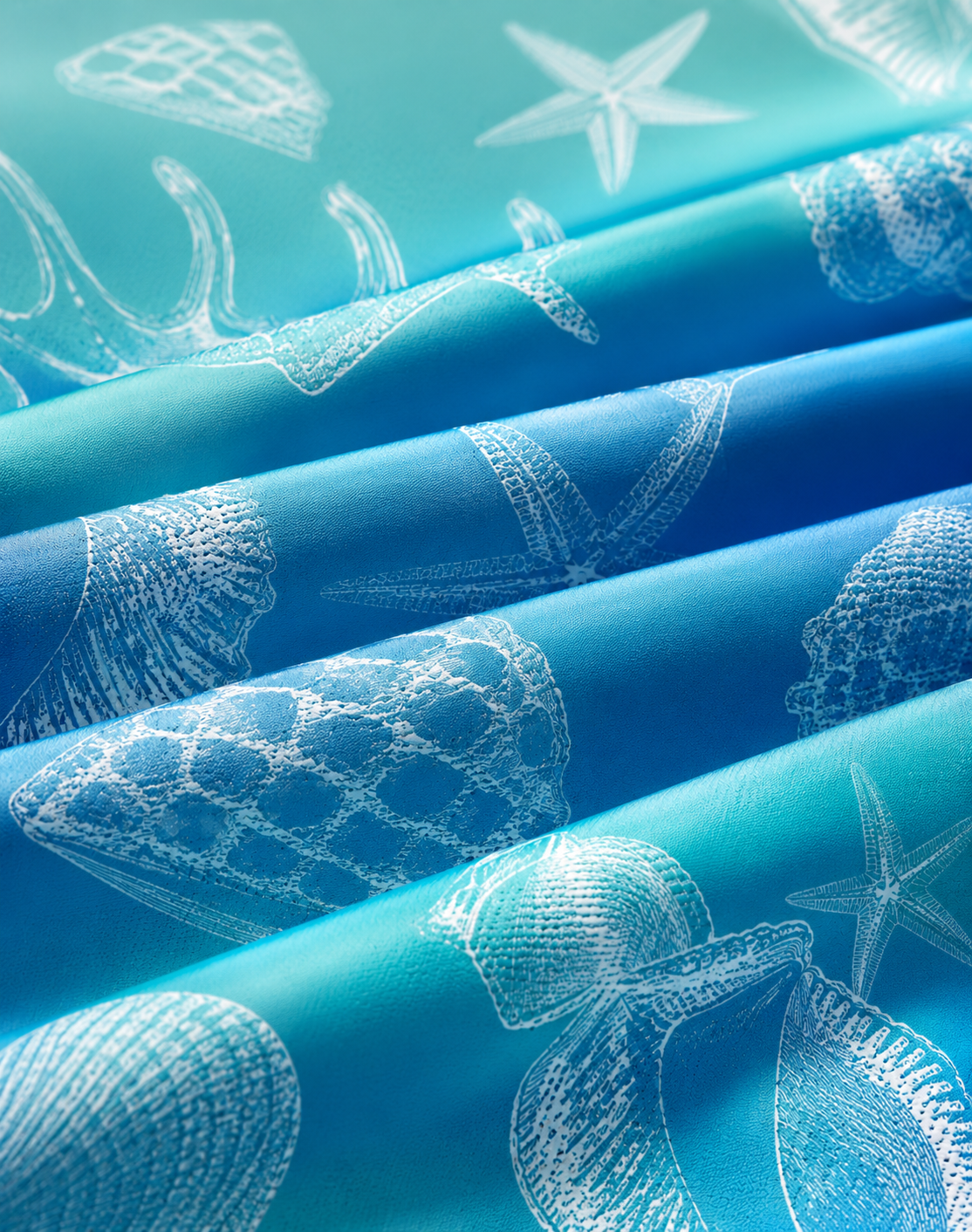 Telas exclusivas con estampados de conchas y estrellas de mar en tonos turquesa y azul